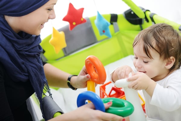 Arabic Muslim mother playing and taking care of her baby-1