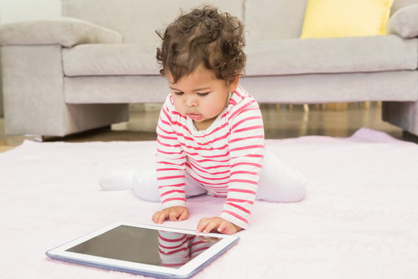 Cute baby on the carpet with tablet at home-1