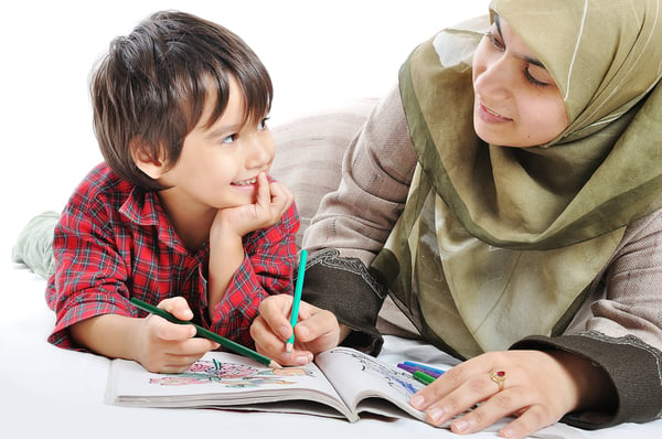 Cute child is painting and playing with his mother