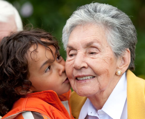 Grandson giving a kiss to his grandmother