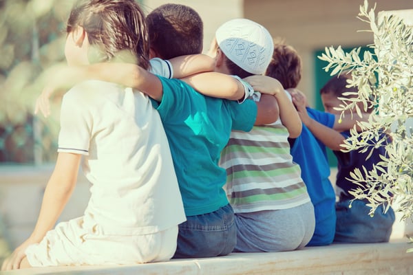 Group of happy children from back