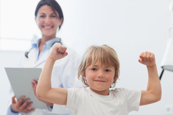 Happy child next to a doctor in hospital ward-1