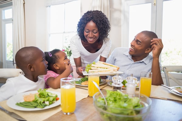 Happy family enjoying a healthy meal together at home in the kitchen