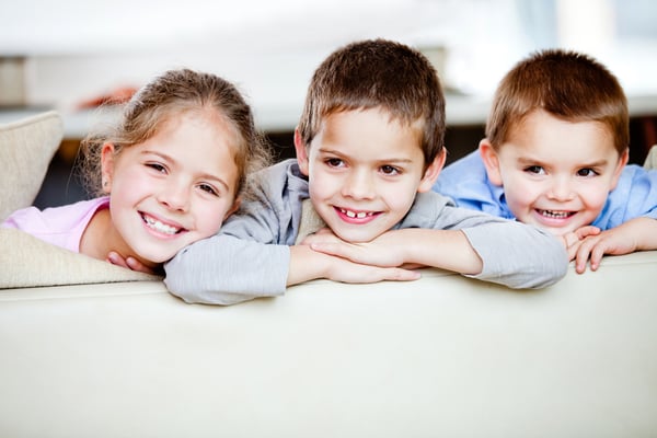 Happy group of children smiling at home