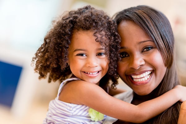 Happy portrait of a mother and daughter smiling