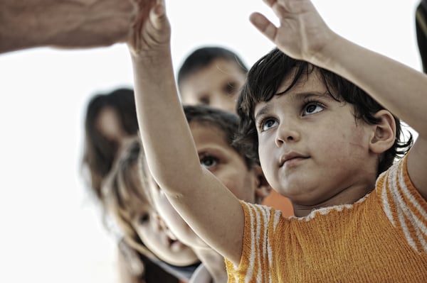 Hungry children in refugee camp, distribution of humanitarian food