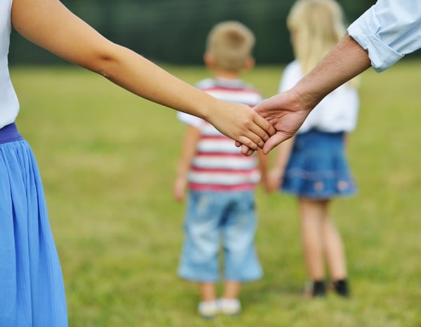 Mother and father hands caring of children