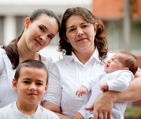 Portrait of a beautiful family with a baby - outdoors