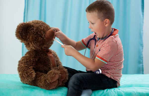 Preschooler and his teddy bear at pediatrician