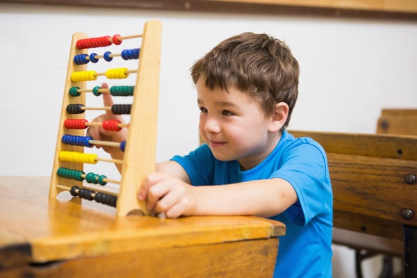 Student doing maths on abacus at elementary school