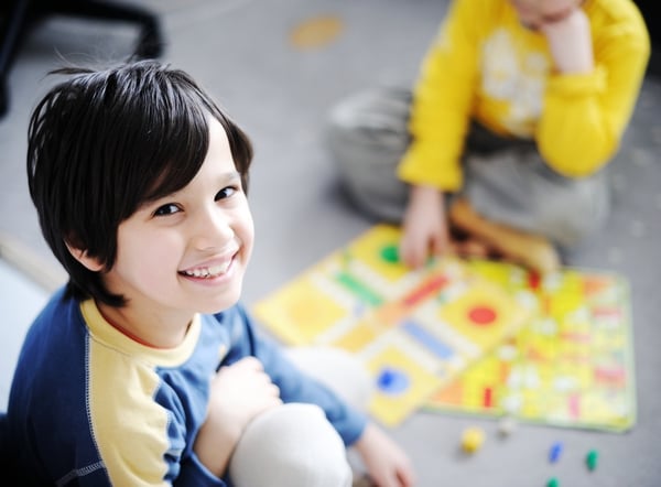 Two kids playing a game of cards-1