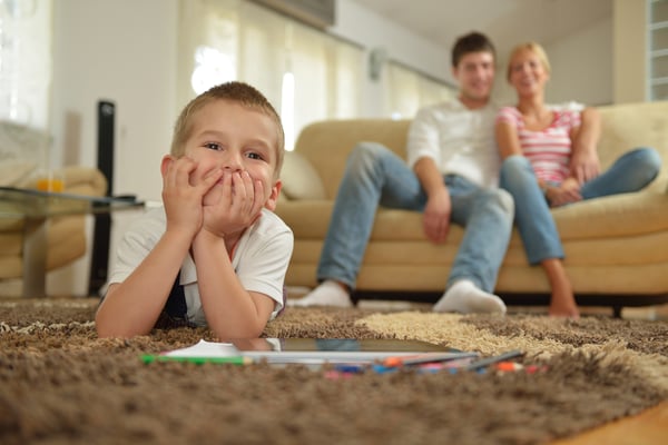 happy young family with kids in bright modern living room have fun and looking big flat lcd tv