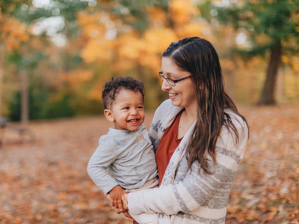 mother and son at a leafy park