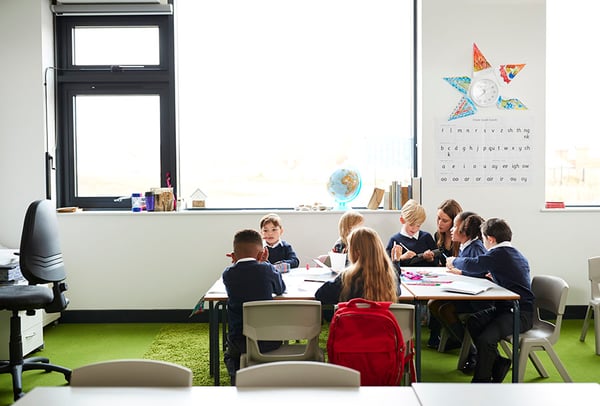 primary school children sitting at table