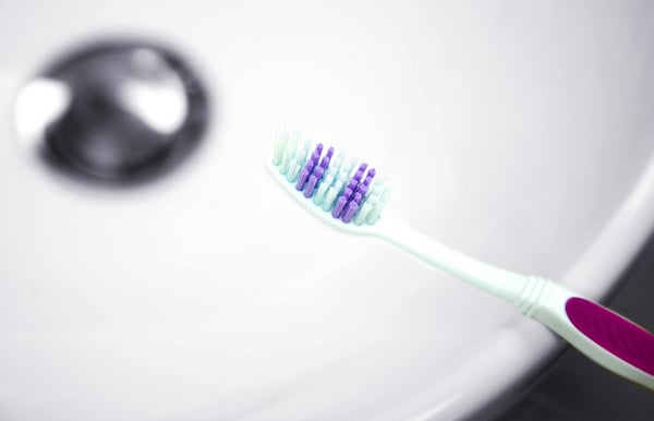 purple toothbrush  on a sink